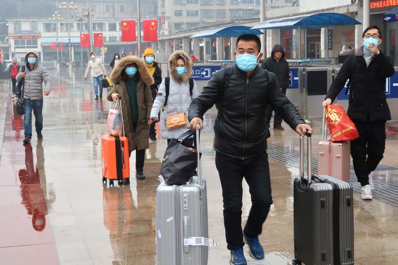 Passengers wearing masks are seen at the Changsha Railway Station, in Hunan