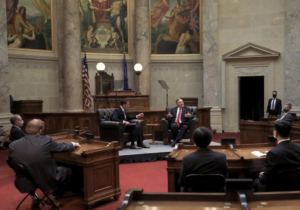 Secretary of State Mike Pompeo , right, responds to a question from Wisconsin Senate President Roger Roth, R-Appleton, during a question and answer sessions with state Republican legislators in the Senate chamber of the Wisconsin State Capitol in Madison, Wis. Wednesday, Sept. 23, 2020. (John Hart/Wisconsin State Journal via AP)