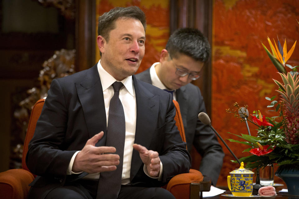 FILE - In this Jan. 9, 2019, file photo, Tesla CEO Elon Musk speaks during a meeting with Chinese Premier Li Keqiang at the Zhongnanhai leadership compound in Beijing. Electric car and solar panel maker Tesla said Friday, Jan. 18, 2019 it plans to cut its staff by about 7 percent. (AP Photo/Mark Schiefelbein, Pool, File)