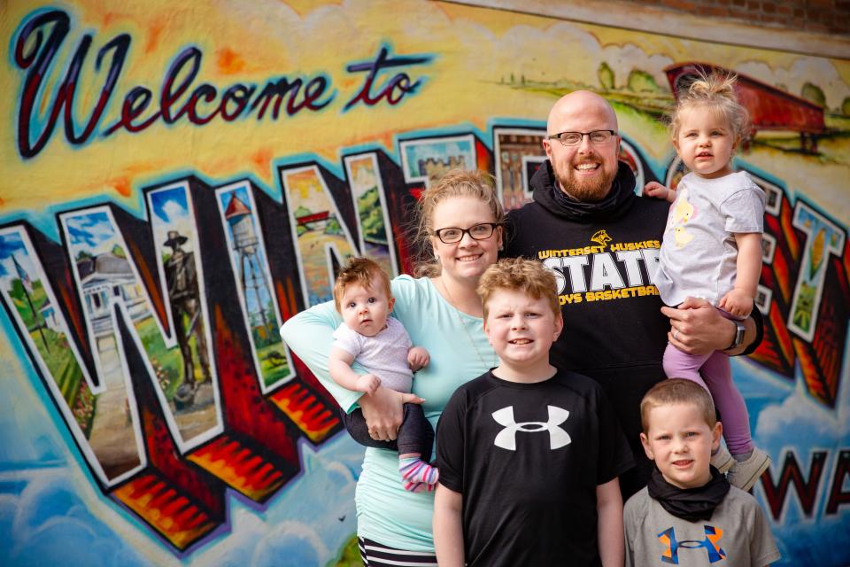 Sarah and Corey Bradley with their kids, Carsyn, 3 months, Camden, 9, Corbin, 5, and Cayson, 2, on the square in Winterset, Iowa, on May 10, 2021. The Bradleys had a baby during the pandemic, but they also contracted COVID-19 just a few weeks before Sarah gave birth.