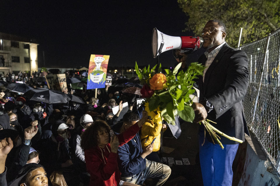 Demonstrator Michael Odiari pleas for calm during a protest over the fatal shooting of Daunte Wright after a traffic stop, outside the Brooklyn Center Police Department, Friday, April 16, 2021, in Brooklyn Center, Minn. (AP Photo/John Minchillo)