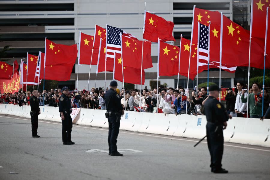 US President Joe Biden motorcade drives past people and Chinese and US national flags in San Francisco, California, on November 14, 2023. (Photo by BRENDAN SMIALOWSKI/AFP via Getty Images)