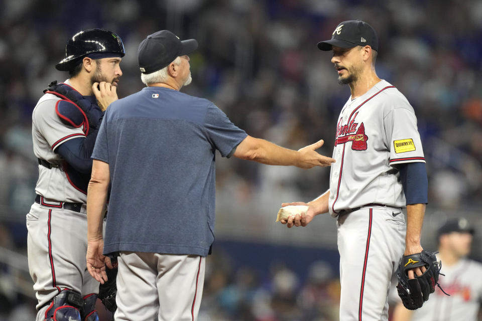 Atlanta Braves pitching coach Rick Kranitz, center, talks with starting pitcher Charlie Morton (50) after Morton gave up a grand slam to Miami Marlins' Jazz Chisholm Jr. during the third inning of a baseball game, Sunday, Sept. 17, 2023, in Miami. At left is catcher Travis d'Arnaud. (AP Photo/Lynne Sladky)