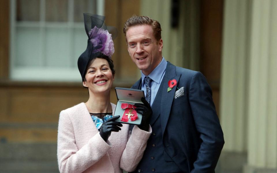 Helen McCrory poses with her husband Damian Lewis after she was awarded an Officer of the Most Excellent Order of the British Empire (OBE) for services to drama in 2017 - STEVE PARSONS/POOL/AFP