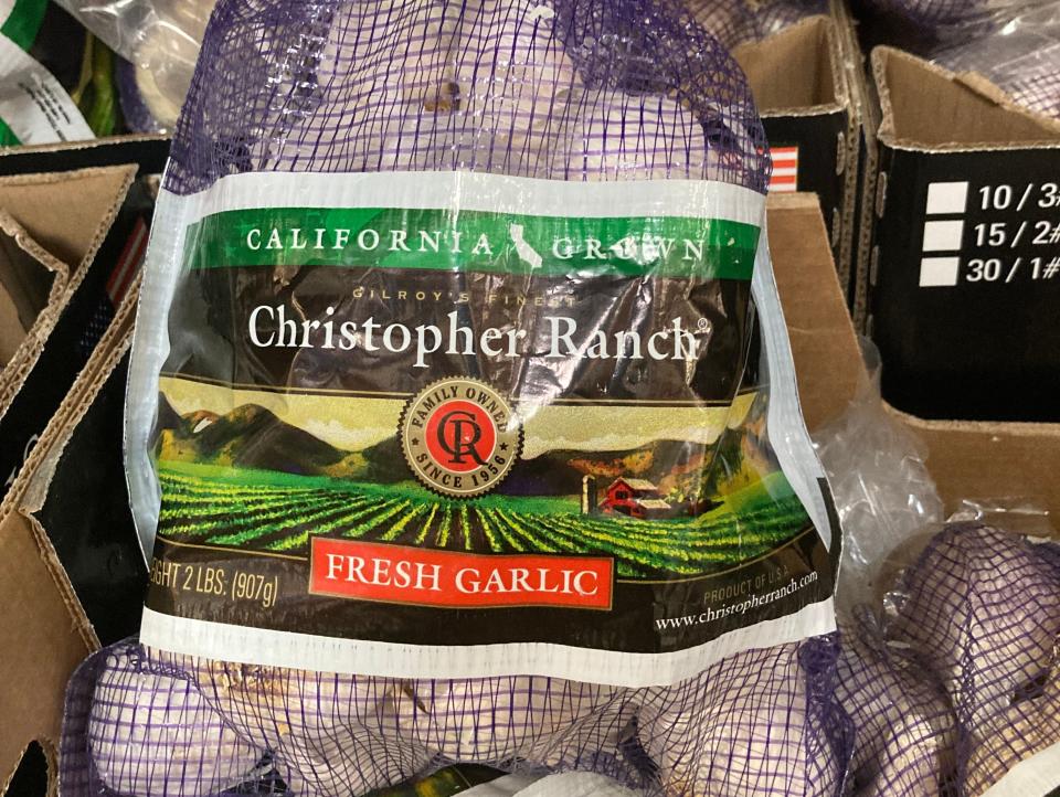 Purple mesh bag of fresh garlic at Costco