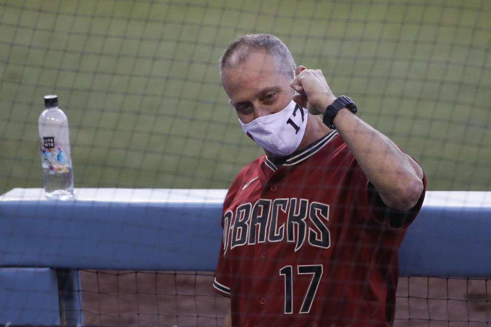 Arizona Diamondbacks manager Torey Lovullo gestures in the dugout during an exhibition baseball game against the Los Angeles Dodgers Monday, July 20, 2020, in Los Angeles. (AP Photo/Marcio Jose Sanchez)