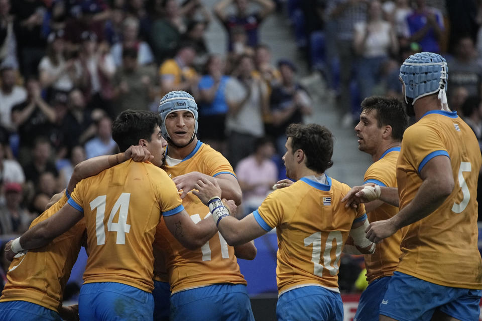 Uruguay players celebrate a try during the Rugby World Cup Pool A match between Uruguay and Namibia at the OL Stadium in Lyon, France, Wednesday, Sept. 27, 2023. (AP Photo/Laurent Cipriani)