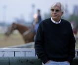 FILE - Trainer Bob Baffert watches a workout at Churchill Downs Tuesday, May 3, 2016, in Louisville, Ky. Baffert will miss the race for the third consecutive year. He served a two-year suspension by Churchill Downs Inc. after his 2021 winner Medina Spirit was disqualified for a failed drug test. But the track’s corporate ownership meted out an additional year of punishment. (AP Photo/Charlie Riedel, File)