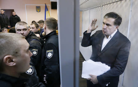 Ukrainian opposition figure and Georgian former President Mikheil Saakashvili gestures inside a defendants' cage as he attends a court hearing in Kiev, Ukraine December 11, 2017. REUTERS/Valentyn Ogirenko