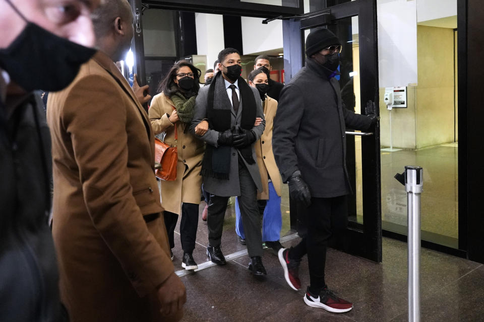 Actor Jussie Smollett, center, leaves to the Leighton Criminal Courthouse, Thursday, Dec. 9, 2021, in Chicago, following a verdict in his trial. Smollett was convicted Thursday on five of six charges he staged an anti-gay, racist attack on himself nearly three years ago and then lied to Chicago police about it. (AP Photo/Nam Y. Huh)