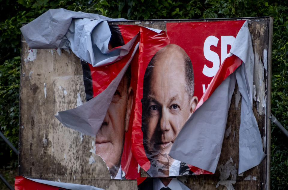 A damaged election poster shows German Chancellor Olaf Scholz in Frankfurt, Germany, Monday, June 10, 2024. (AP Photo/Michael Probst)