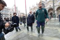 Italy's goalkeeper Gianluigi Donnarumma, and team manager Gianluca Vialli are seen in St. Mark's Square during a solidarity visit to Venice following the exceptional high water that brought the city to its knees, in Venice, northern Italy, Saturday, Nov. 16, 2019. Four days ago, the Italian lagoon city experienced its worst flooding in more than 50 years. (Andrea Merola/ANSA via AP)
