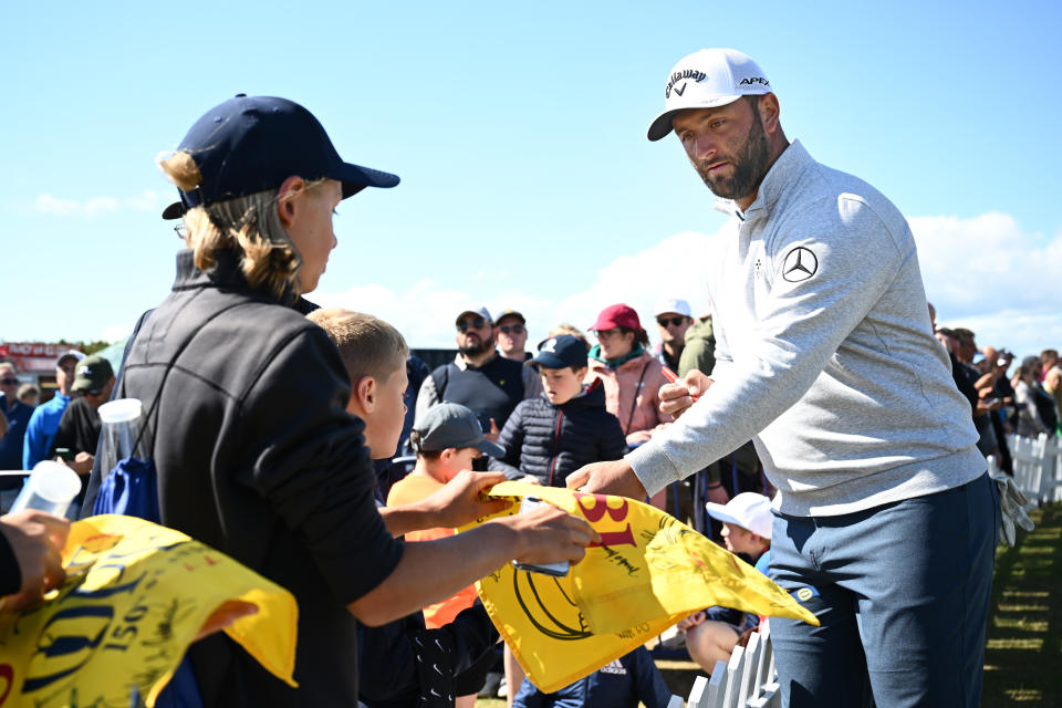 ST ANDREWS, SCOTLAND - JULY 13: Jon Rahm of Spain signs autographs during a practice round prior to The 150th Open at St Andrews Old Course on July 13, 2022 in St Andrews, Scotland. (Photo by Stuart Franklin/R&A/R&A via Getty Images)