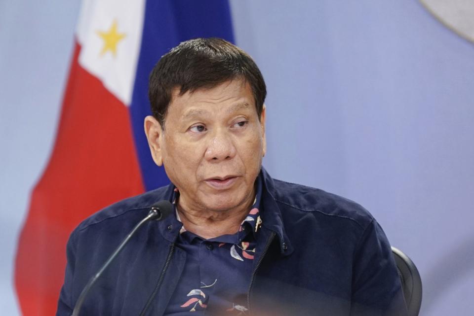 Philippine President Rodrigo Duterte speaks at a microphone