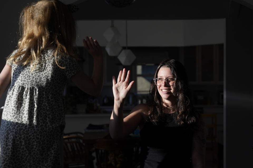 Hannah Levy high fives her daughter Aylah, 6, in Albany, Calif., Wednesday, Nov. 8, 2023. (AP Photo/Jeff Chiu)