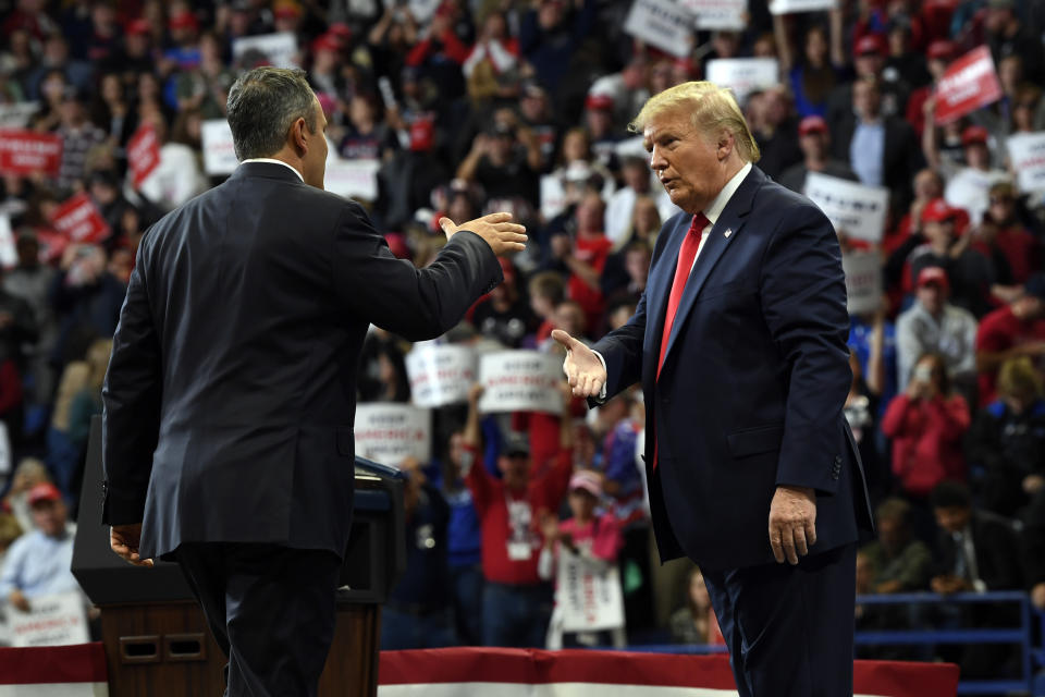 President Donald Trump, left, greets Kentucky Gov. Matt Bevin, right, during a campaign rally in Lexington, Ky., Monday, Nov. 4, 2019. (AP Photo/Susan Walsh)