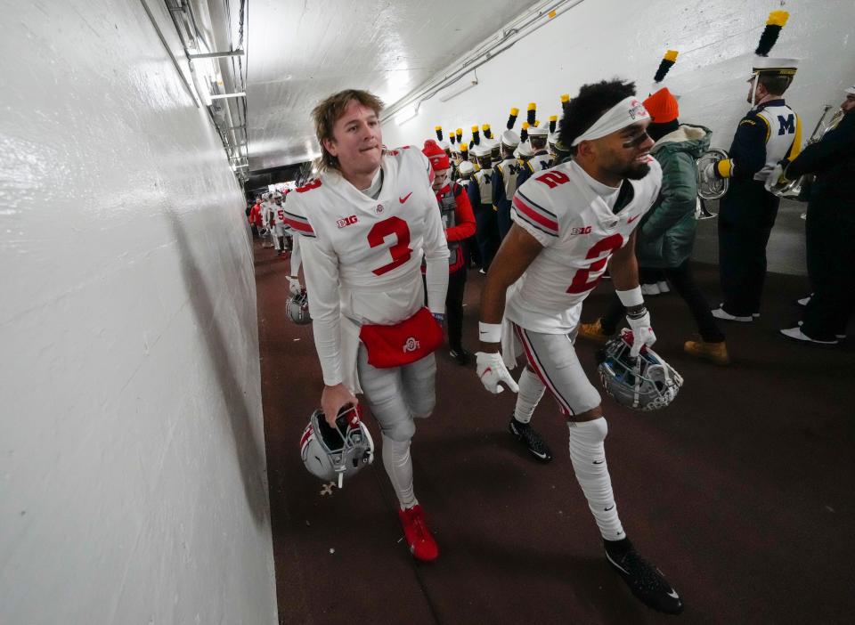 Ohio State Buckeyes quarterback Quinn Ewers (3) and wide receiver Chris Olave (2) walk up the tunnel to the locker room prior to the NCAA football game against the Michigan Wolverines at Michigan Stadium in Ann Arbor on Monday, Nov. 29, 2021. 