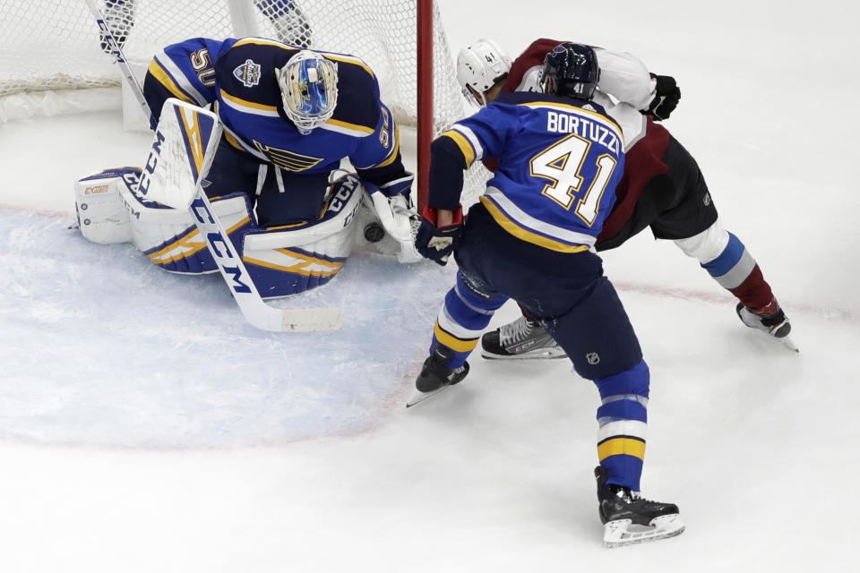 Colorado Avalanche's Pierre-Edouard Bellemare, of France, is unable to score past St. Louis Blues goaltender Jordan Binnington (50) as Blues' Robert Bortuzzo, front right, watches during the second period of an NHL hockey game Monday, Dec. 16, 2019, in St. Louis. (AP Photo/Jeff Roberson)