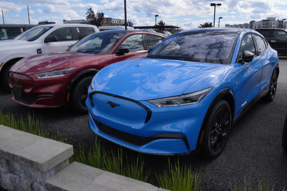 A Ford Mustang Mach-E vehicles are shown on a dealership lot, Wednesday, May 29, 2024, in Salem, N.H. (AP Photo/Charles Krupa, Pool)