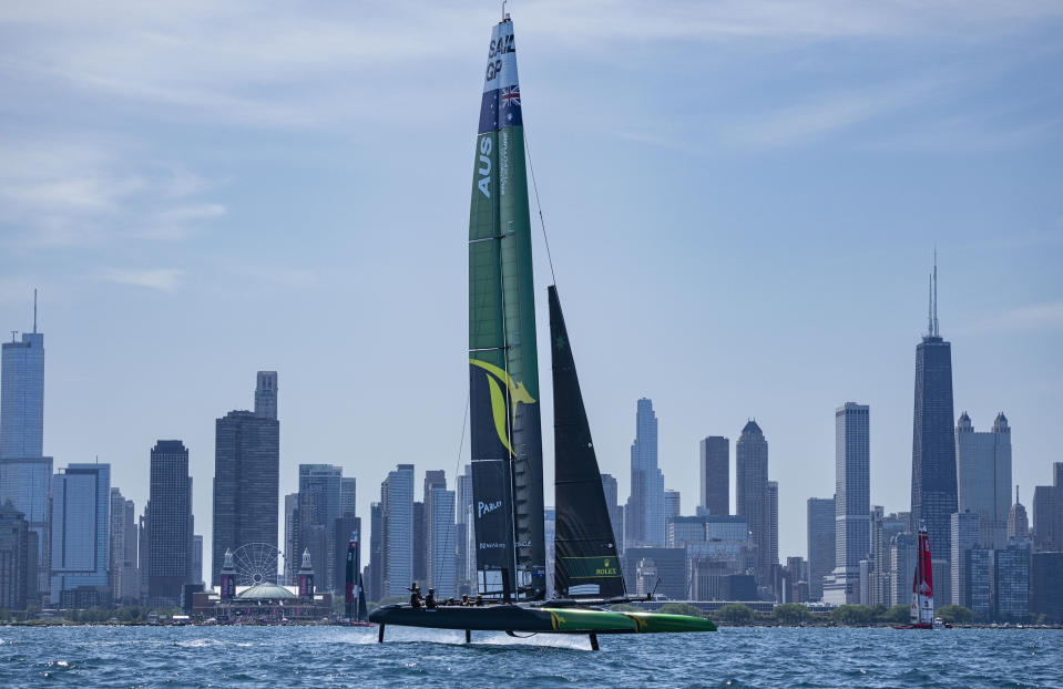 In this photo provided by SailGP, Australia's SailGP Team, Denmark's SailGP Team presented by ROCKWOOL, and Switzerland's SailGP Team sail past the Chicago skyline during the United States Sail Grand Prix sailing race in Chicago, Sunday, June 19, 2022. (Bob Martin/SailGP via AP)