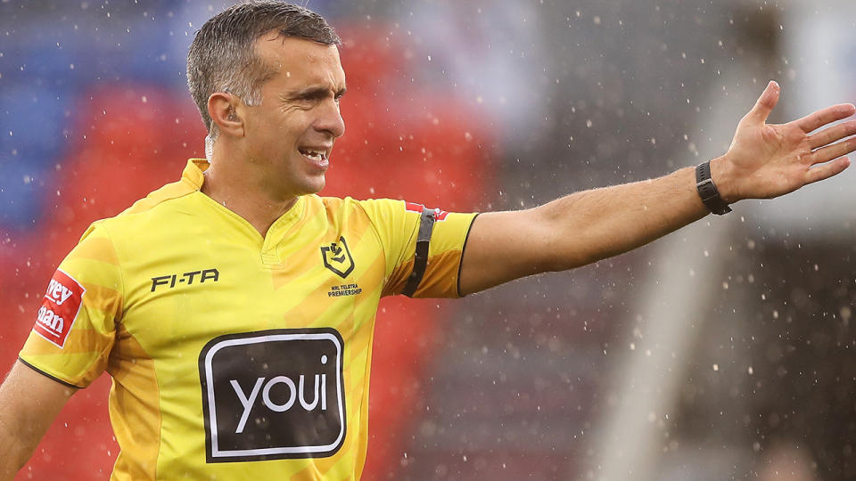 NRL referee Matt Cecchin is pictured awarding a try.