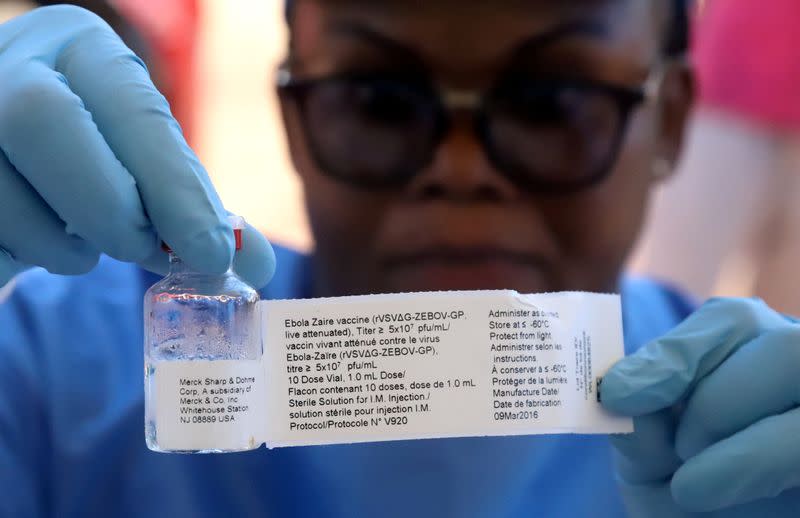 FILE PHOTO: A World Health Organization worker prepares to administer a vaccination during the launch of a campaign aimed at beating an outbreak of Ebola in the port city of Mbandaka