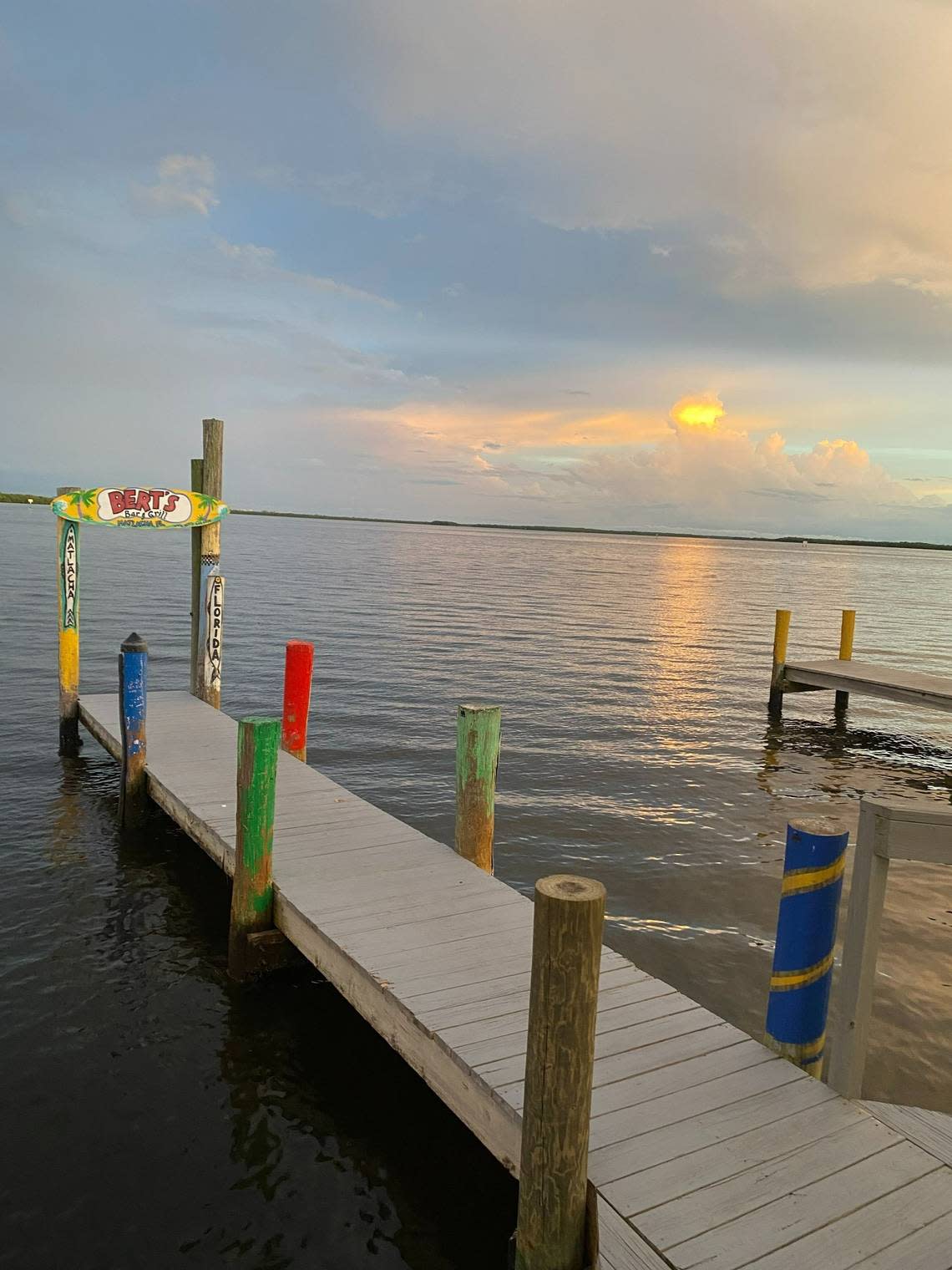 The sun sets over the dock at Bert’s Bar & Grill in Matlacha in Southwest Florida, on July 3, 2022. Hurricane Ian wiped out the popular spot, known for its all-you-can eat fried shrimp, live music and dockside dining. Ian hit the coast of Southwest Florida as a Category 4 storm on Wednesday, Sept. 28, 2022.