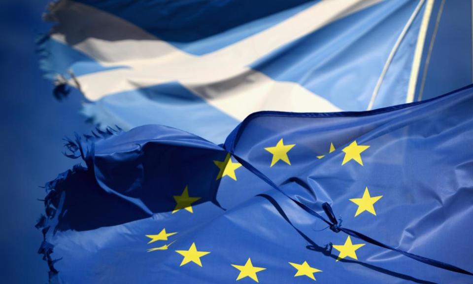 A European Union flag and saltire flag blow in the wind.
