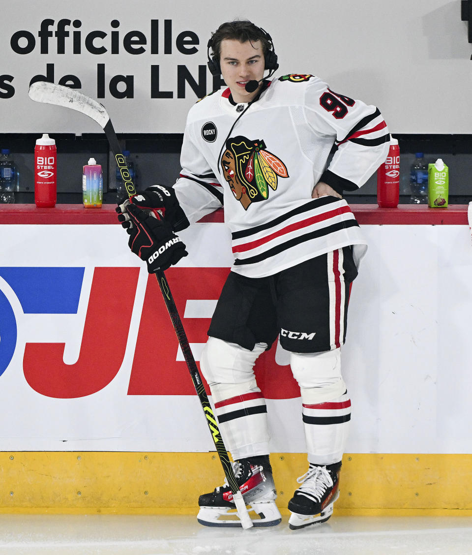 Chicago Blackhawks' Connor Bedard talks to a broadcaster prior to an NHL hockey game against the Montreal Canadiens in Montreal, Saturday, Oct. 14, 2023. (Graham Hughes/The Canadian Press via AP)