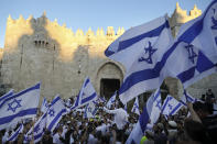 Jewish ultranationalists wave Israeli flags during the "Flags March," next to Damascus gate, outside Jerusalem's Old City, Tuesday, June 15, 2021. (AP Photo/Mahmoud Illean)