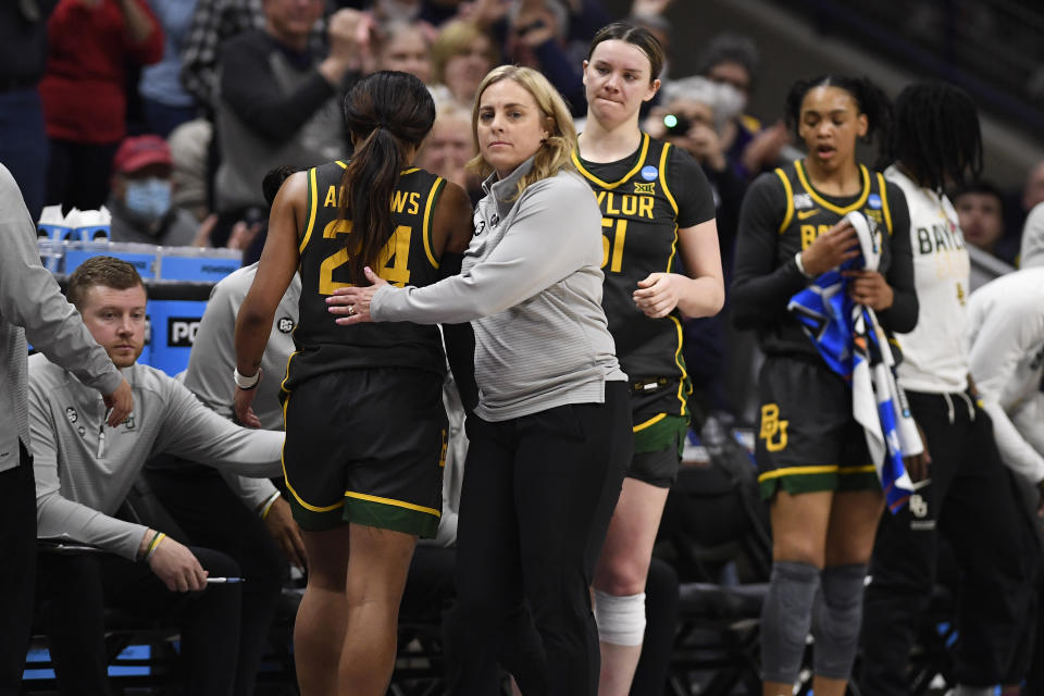 Baylor head coach Nicki Collen, center front, embraces Baylor's Sarah Andrews (24) who comes off the court in the second half of a second-round college basketball game against UConn in the NCAA Tournament, Monday, March 20, 2023, in Storrs, Conn. (AP Photo/Jessica Hill)