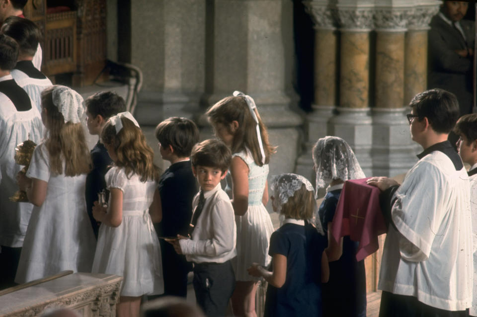 Photo credit: JFK Jr. alongside his sister Caroline and his cousins at their Uncle Bobby's funeral. / Getty