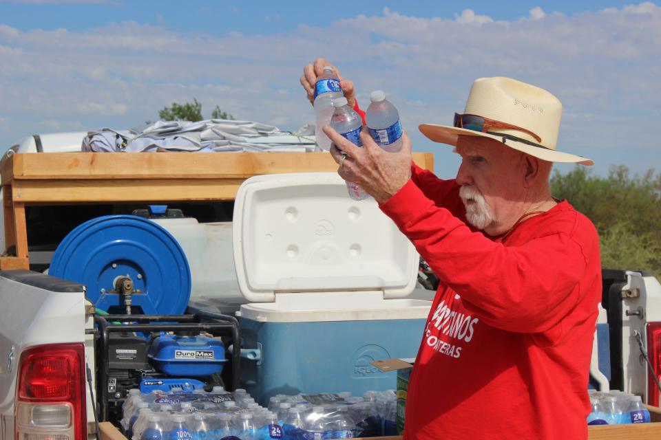 Tom Wingo, 76, refills water drums and gives water to migrants on the Organ Pipe Cactus National Monument west of Lukeville on Aug. 22, 2023.