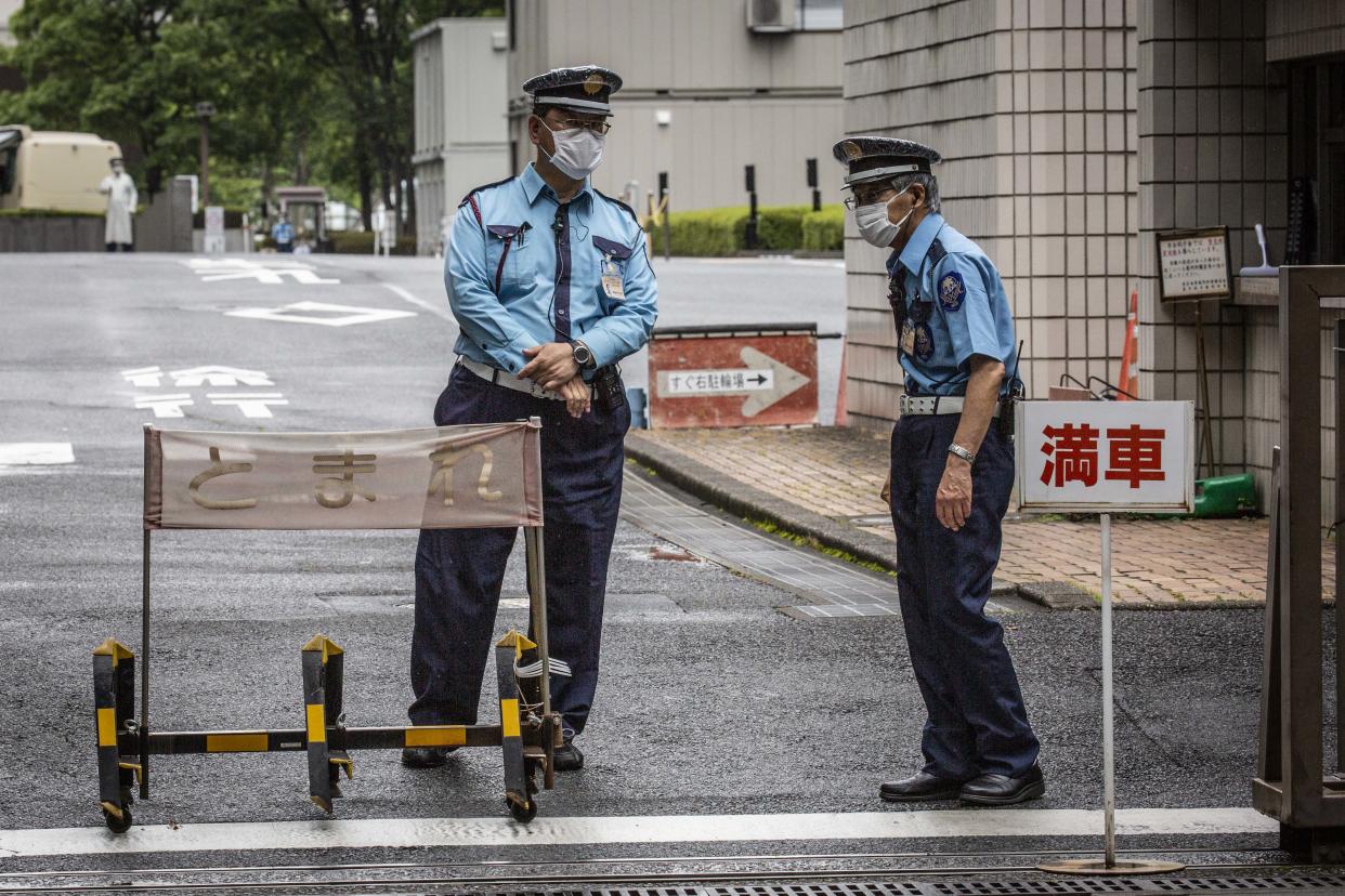 TOKYO, JAPAN - JUNE 14: Security guards stand at an entrance to the Tokyo District Court on June 14, 2021 in Tokyo, Japan. The trial of Michael Taylor and his son Peter, two Americans accused of helping former Nissan Chairman Carlos Ghosn escape from Japan in a box to Lebanon while on bail in 2019, opened on June 14 at the Tokyo District Court. (Photo by Yuichi Yamazaki/Getty Images)