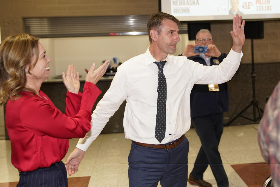 U.S. Rep. Frank Mrvan, D-Ind., acknowledges the applause of supporters and his wife Jane, right, during an election night party Tuesday, Nov. 8, 2022, in Merrillville, Ind. (AP Photo/Charles Rex Arbogast)