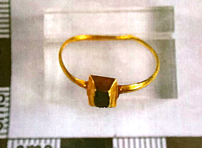 <em>The tiny gold ring is small enough to find on a child’s hand and is set with a square sapphire (SWNS)</em>