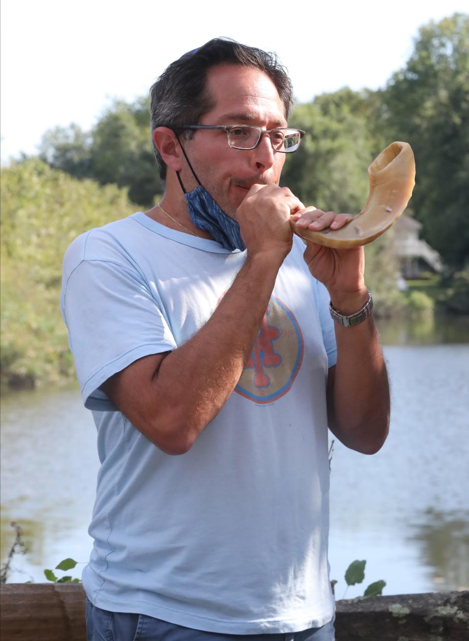 Adam Levine blows the shofar during a Rosh Hashana Tashlich service at the Camelot community in New City Sept. 7, 2021.