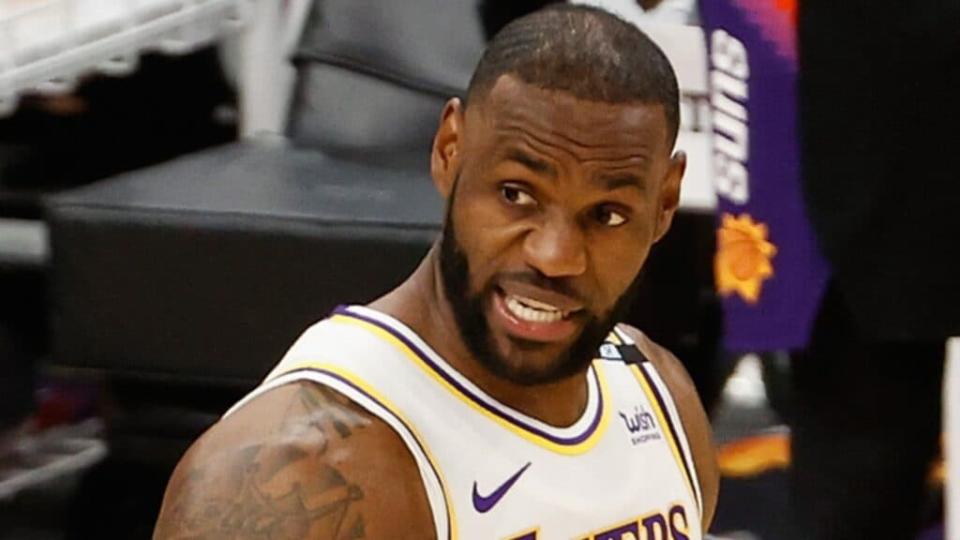 LeBron James of the Los Angeles Lakers handles the ball against the Phoenix Suns during the first half of Game One of the Western Conference first-round playoff series Sunday at Phoenix Suns Arena. (Photo by Christian Petersen/Getty Images)