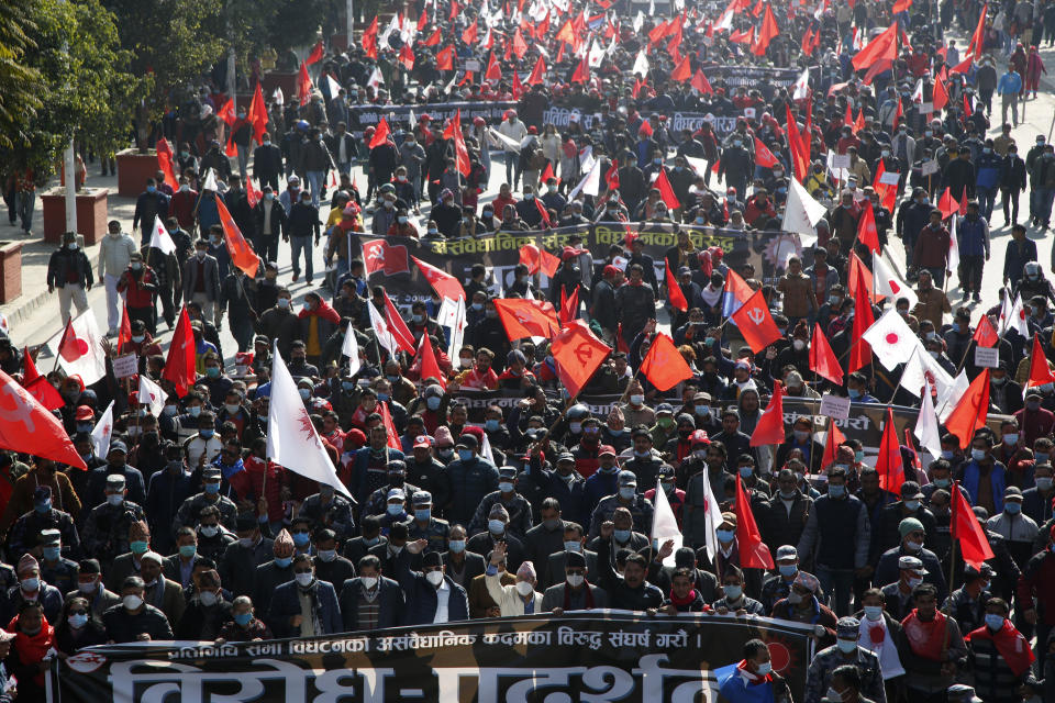 Nepalese supporters of the splinter group in the governing Nepal Communist Party participate in a protest in Kathmandu, Nepal, Tuesday, Dec. 29, 2020. Tens of thousands of supporters of the splinter group rallied in the capital on Tuesday demanding the ouster of the prime minister and the reinstatement of the Parliament he dissolved amid an escalating feud in the party. (AP Photo/Niranjan Shrestha)