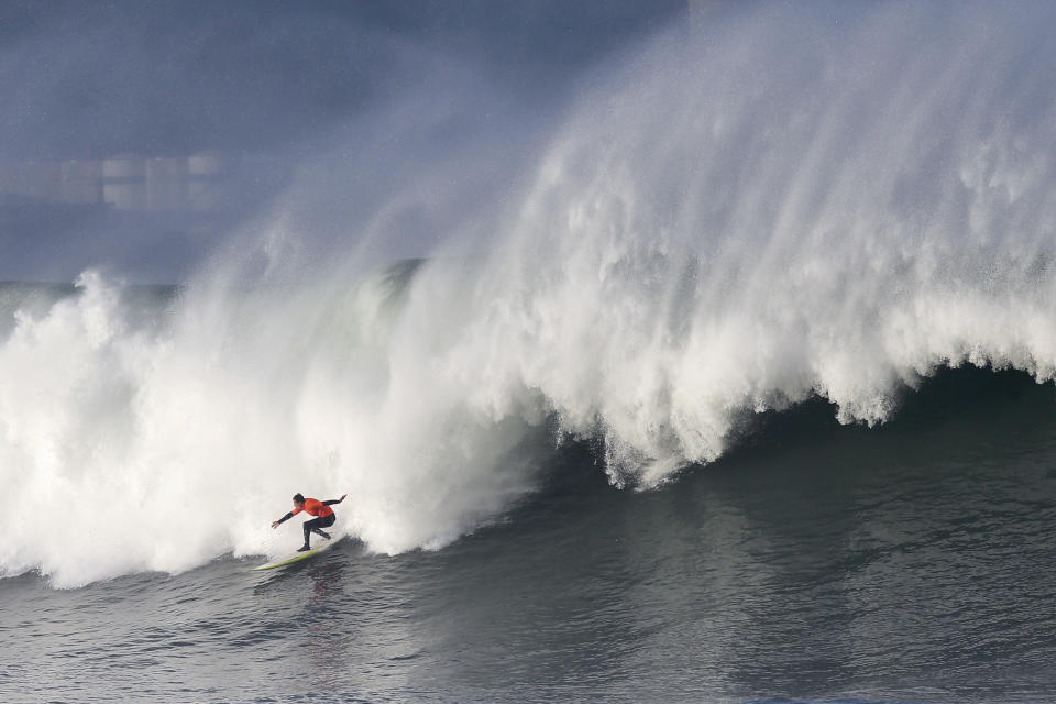 A surfer rides a wave during the Punta Galea Big Wave Challenge in Punta Galea, near Bilbao