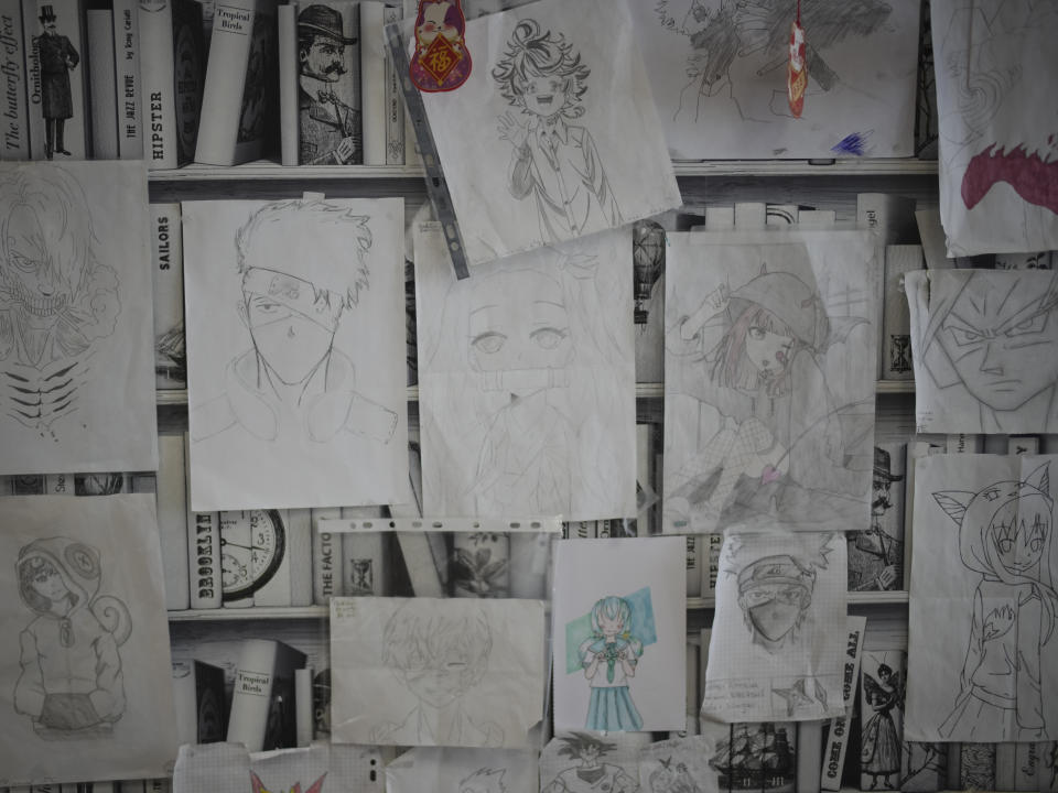 Student drawings of anime characters hang on the wall in the library at Ibn Khaldoun, a private Muslim school, in Marseille, southern France, Tuesday, April 16, 2024. (AP Photo/Daniel Cole)