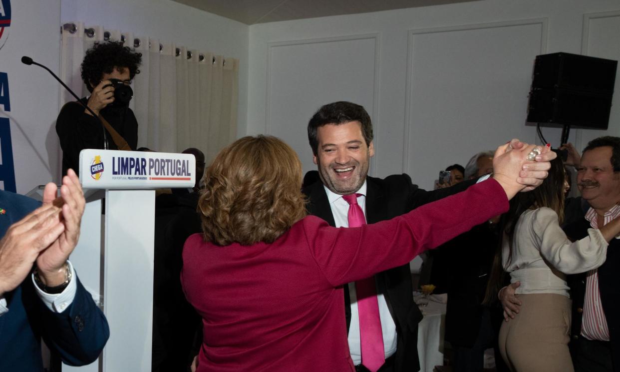 <span>André Ventura, the Chega party leader, dances with the main candidate for the Vila Real district at a dinner event in Mouçós, Vila Real, Portugal.</span><span>Photograph: Gonçalo Fonseca/The Guardian</span>