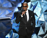 <p>Dave Chappelle wears oversize square glasses with his black suit while presenting at the 2018 Oscars. (Photo: Getty Images) </p>