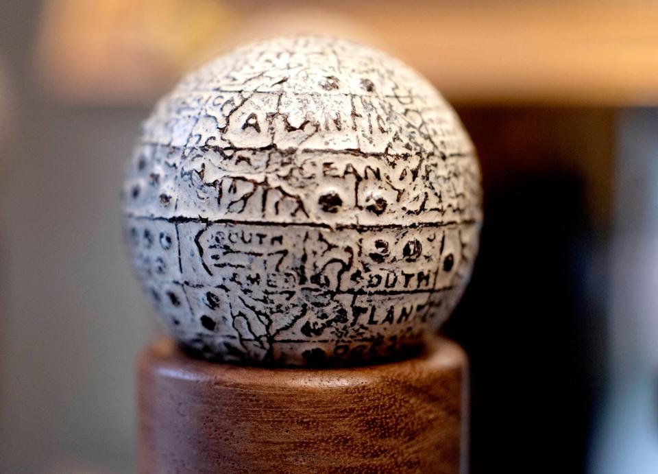 This gutta-percha ball from 1902 at the Old Golf Shop features a world map.