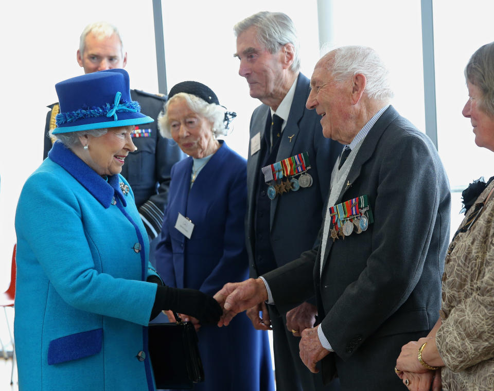 FOLKESTONE, ENGLAND - MARCH 26:  Queen Elizabeth II meets Mrs K Foster (L), Wing Commander Paul Farnes (C) and Squadron Leader Tom Pickering as she visits the National Memorial to the Few ahead of opening a new wing on March 26, 2015 in Folkestone, England.  (Photo by Chris Jackson - WPA Pool/Getty Images)