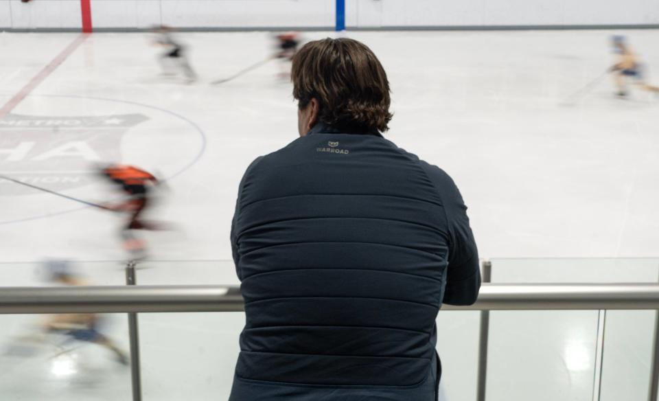 Eric Perardi watches his son's hockey game at the Crossover sports and entertainment facility in Cedar Park. Perardi first met Saint Jovite Youngblood and his family in 2018 while serving as a volunteer ice hockey league coach after Youngblood’s son joined Perardi’s son’s team.