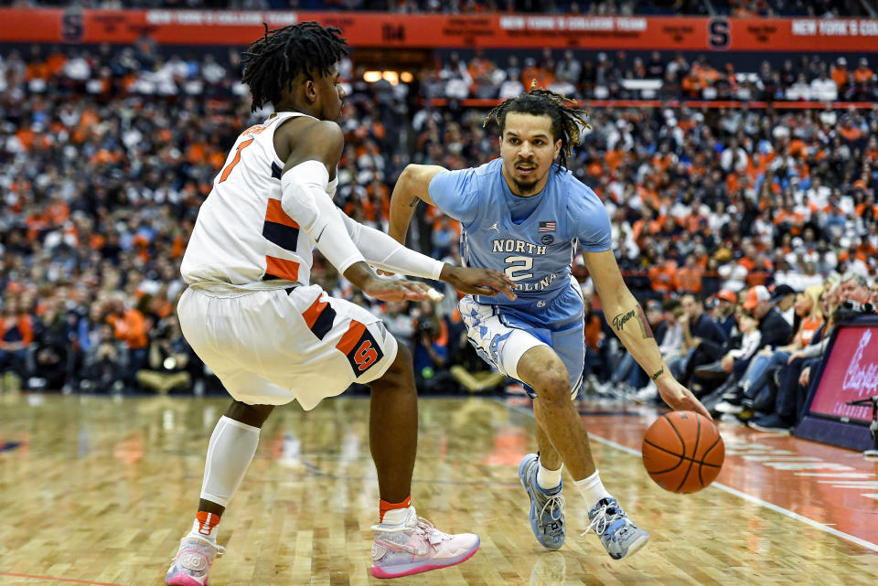 North Carolina guard Cole Anthony (2) is defended by Syracuse forward Quincy Guerrier during the first half of an NCAA college basketball game in Syracuse, N.Y., Saturday, Feb. 29, 2020. (AP Photo/Adrian Kraus)