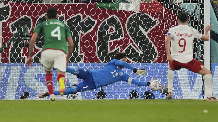 Mexico's goalkeeper Memo Ochoa saves a penalty kick from Poland's Robert Lewandowski