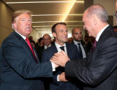 <p>Turkish President Tayyip Erdogan chats with President Trump and French President Emmanuel Macron, center, at NATO headquarters in Brussels on July 11, 2018. (Photo: Murat Cetinmuhurdar/Presidential Palace/handout via Reuters) </p>