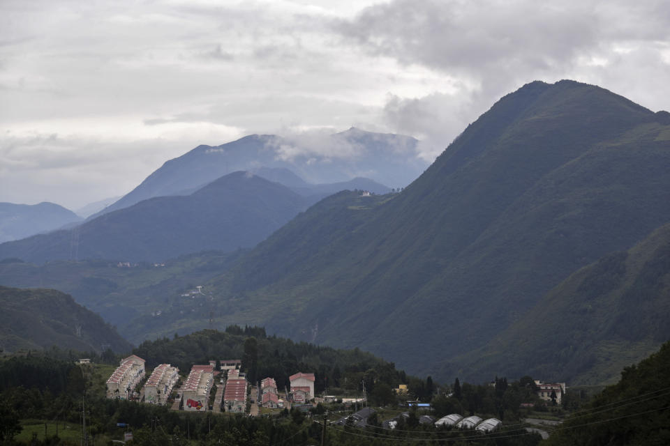 New village houses built by the Chinese government for ethnic monitory sit on the mountain in Ganluo county, southwest China's Sichuan province on Sept. 10, 2020. China's ruling Communist Party says its initiatives have helped to lift millions of people out of poverty. Yi ethnic minority members were moved out of their mountain villages in China’s southwest and into the newly built town in an anti-poverty initiative. (AP Photo/Andy Wong)